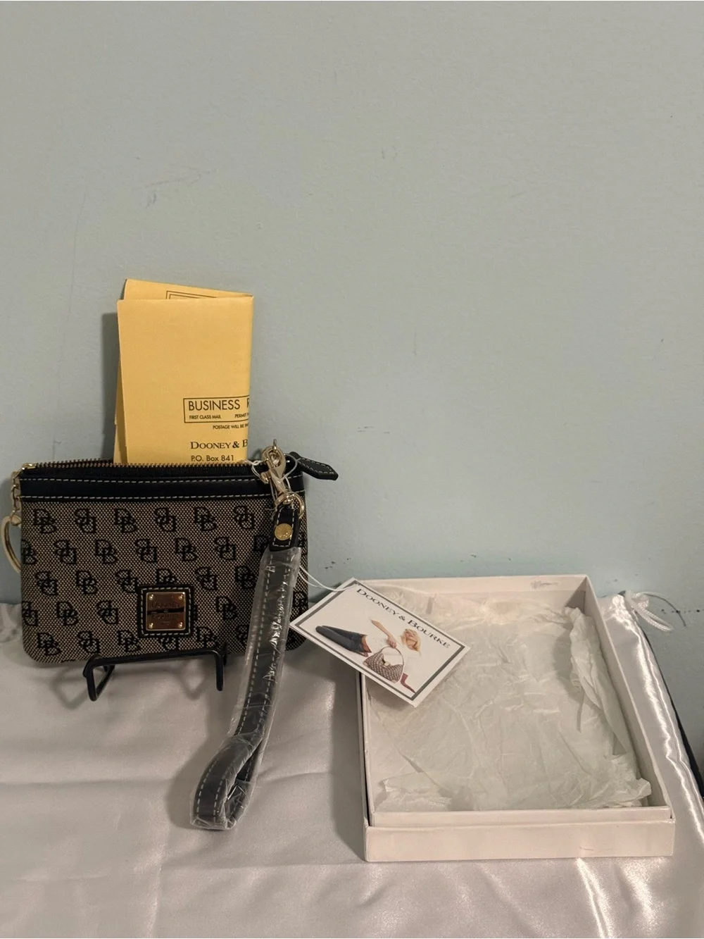 Dooney and Bourke NWT Medium logo wristlet. Comes in a box!